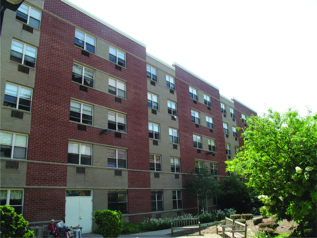 An apartment building with an outdoor lounge